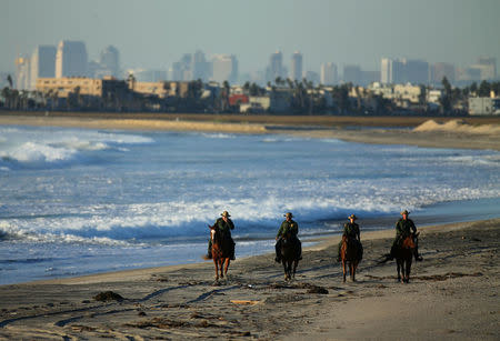 U.S. Border Patrol agents on horseback patrol along a beach just north of the U.S.-Mexico border near San Diego, California, U.S., November 10, 2016. REUTERS/Mike Blake