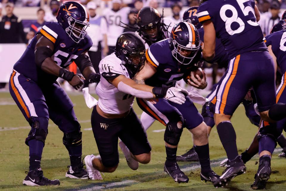 Virginia Cavaliers quarterback Brennan Armstrong (5) is sacked by Wake Forest Demon Deacons defensive back Luke Masterson (12) earlier this season. Masterson led Wake Forest in tackles after switching to linebacker, and is playing in the Hula Bowl on Saturday in Orlando with former Gulf Coast High teammate Cameron Kaye.