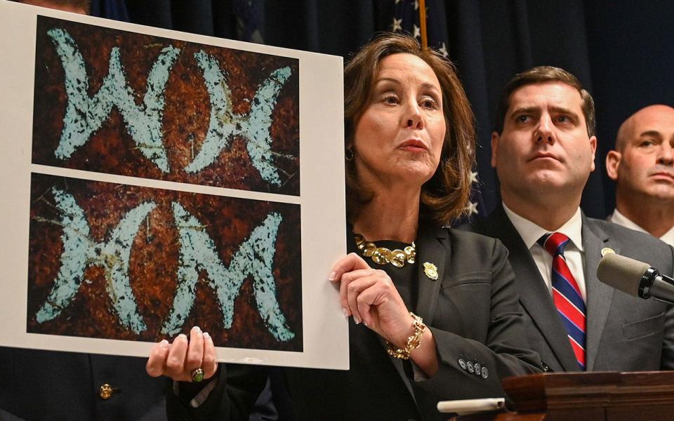 Geraldine Hart holds photo of belt