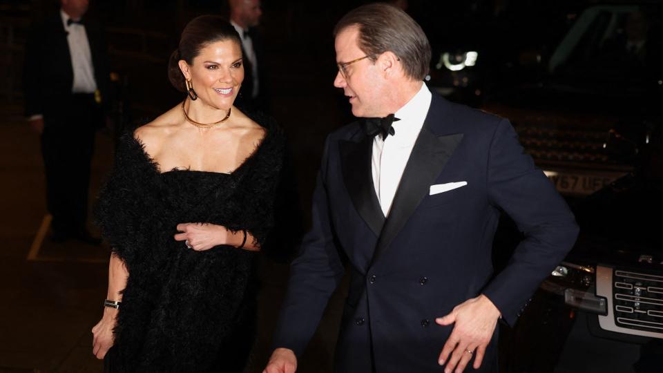 victoria in black dress and daniel in suit exiting car