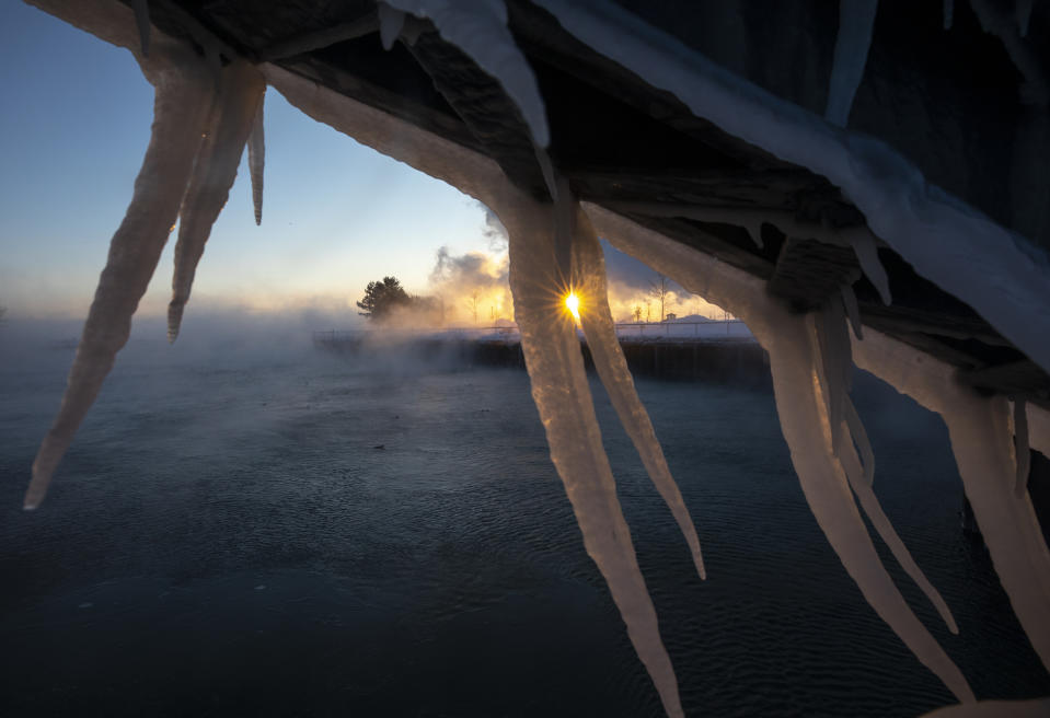 The sun rises behind icicles formed on the harbor in Port Washington, Wis., on Jan. 30, 2019. A deadly arctic deep freeze enveloped the Midwest with record-breaking temperatures. (Photo: Jeffrey Phelps/AP)