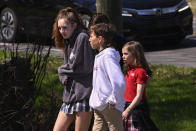 A family leave a reunification site in Nashville, Tenn., Monday, March 27, 2023 after several children were killed in a shooting at Covenant School in Nashville, officials say. The suspect is dead after a confrontation with police. (AP Photo/John Amis)