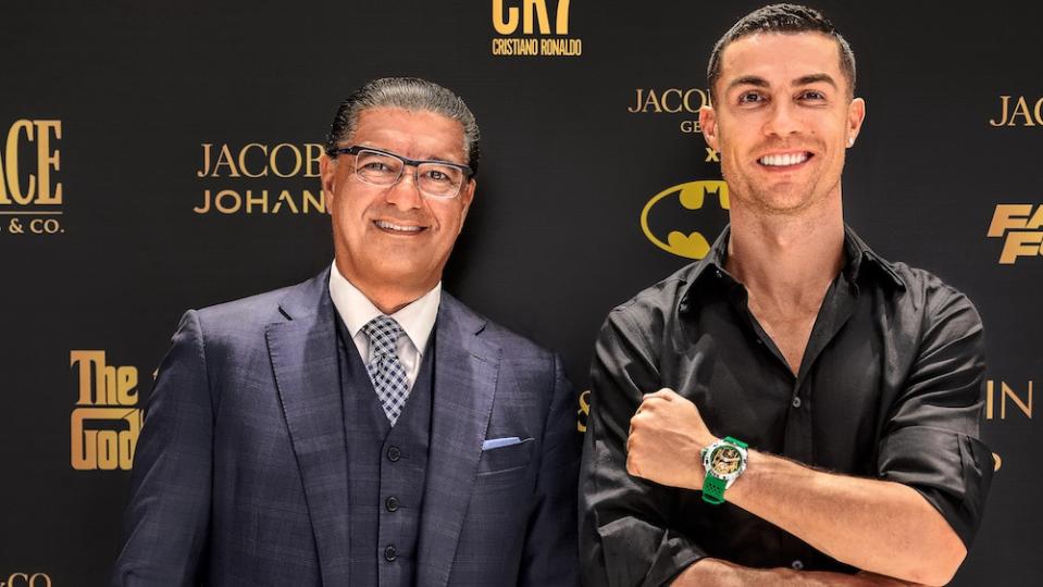 Cristiano Ronaldo is seen standing next to Jacob & Co. founder Jacob Arabo while the soccer player wears the brand's "Heart Of CR7 Baguette" timepiece.