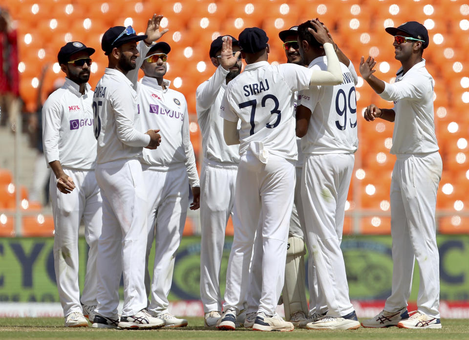 Teammates congratulate India's Ravichandran Ashwin, second right, after dismissing England's captain Joe Root during the third day of fourth cricket test match between India and England at Narendra Modi Stadium in Ahmedabad, India, Saturday, March 6, 2021. (AP Photo/Aijaz Rahi)