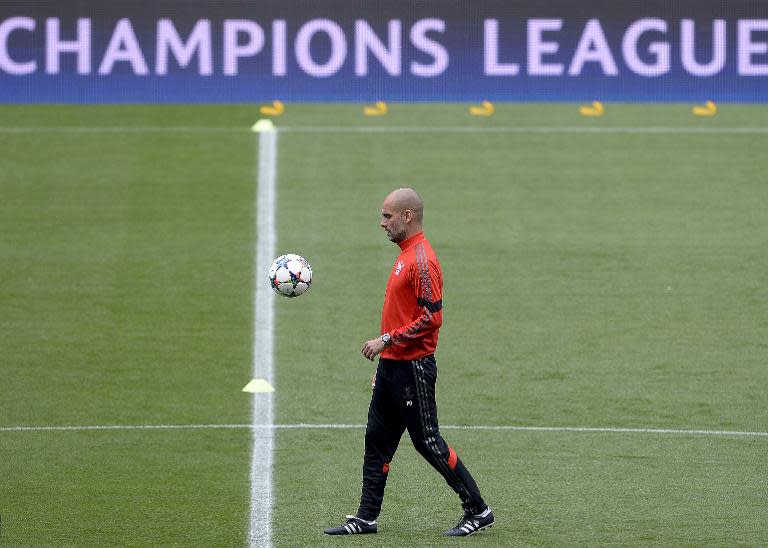 Bayern Munich's Spanish head coach Pep Guardiola eyes a ball during a training session at the Camp Nou stadium on May 5, 2015