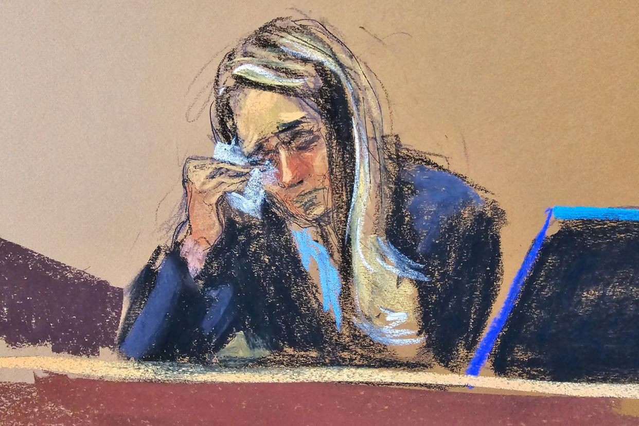 Courtroom sketch of Hope Hicks holding a tissue to her eye while on the witness stand.