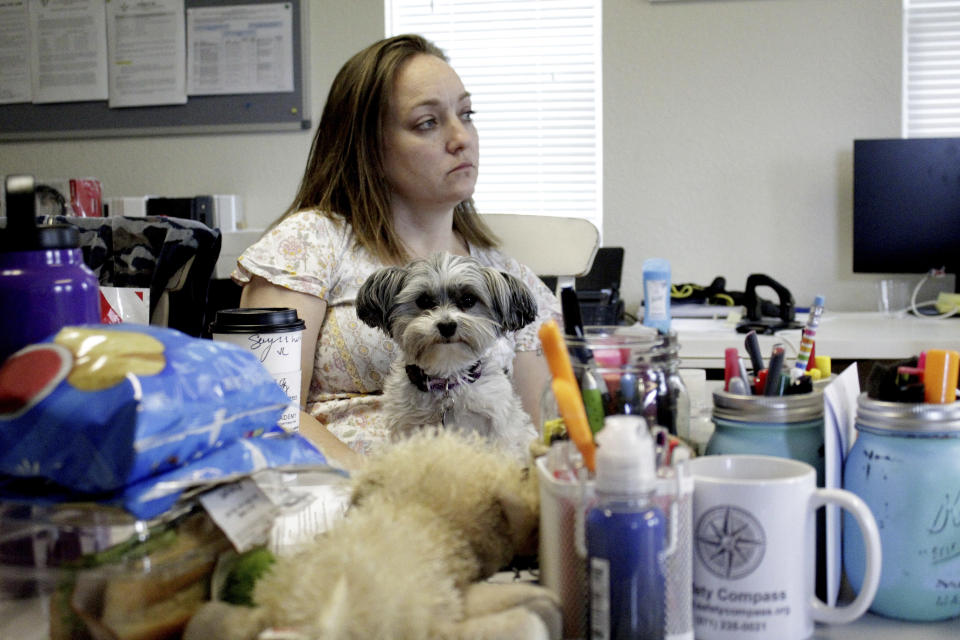 Cassie Trahan, co-founder and executive director of A Village for One, sits in her office at her nonprofit in Oregon City, Ore., in this May 4, 2022, photo. Trahan says case dismissals due to an acute shortage of public defenders in Oregon is affecting her clients' mental health as cases against their abusers stall. A post-pandemic glut of delayed cases has exposed shocking constitutional landmines impacting defendants and crime victims alike in Oregon, where an acute shortage of public defenders has even led judges to dismiss serious cases. (AP Photo/Gillian Flaccus)
