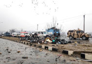 Indian soldiers examine the debris after an explosion in Lethpora in south Kashmir's Pulwama district February 14, 2019. REUTERS/Younis Khaliq