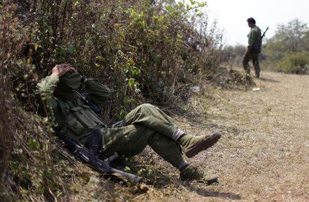 A rebel soldier of Myanmar National Democratic Alliance Army (MNDAA) rests near a military base in Kokang region, March 11, 2015. REUTERS/Stringer