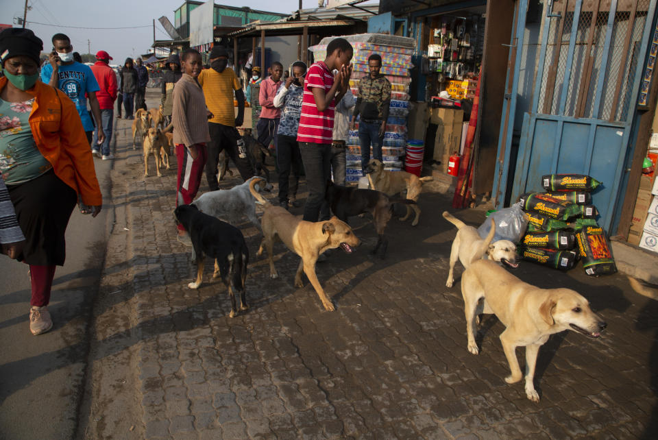 People make their way down a busy street in the Diepsloot Township, north of Johannesburg, Thursday, Aug. 26, 2021. A survey of people aged 18-24 in 15 African countries found that many have lost jobs or have seen their education disrupted by the pandemic. (AP Photo/Denis Farrell)