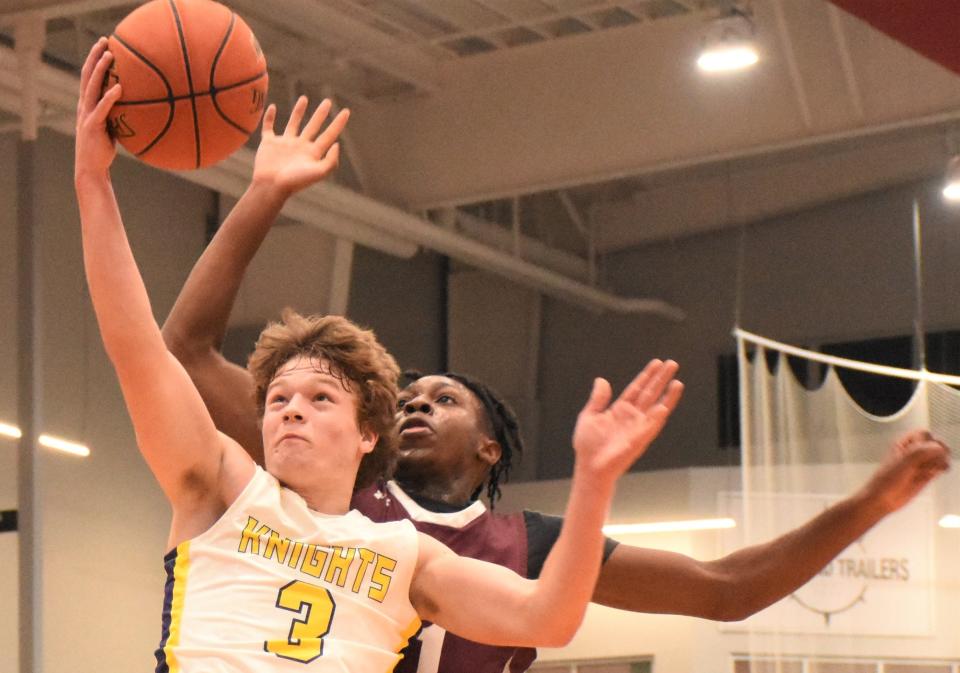 Holland Patent's Andrew Jones (3) approaches the basket at the Nexus Center Friday with Clinton defender Tega Igho in pursuit.