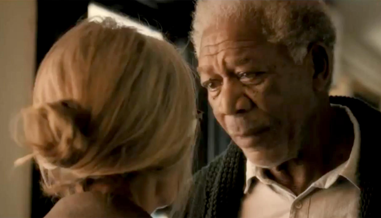 Keaton with Morgan Freeman, about to share a pillowy kiss in 