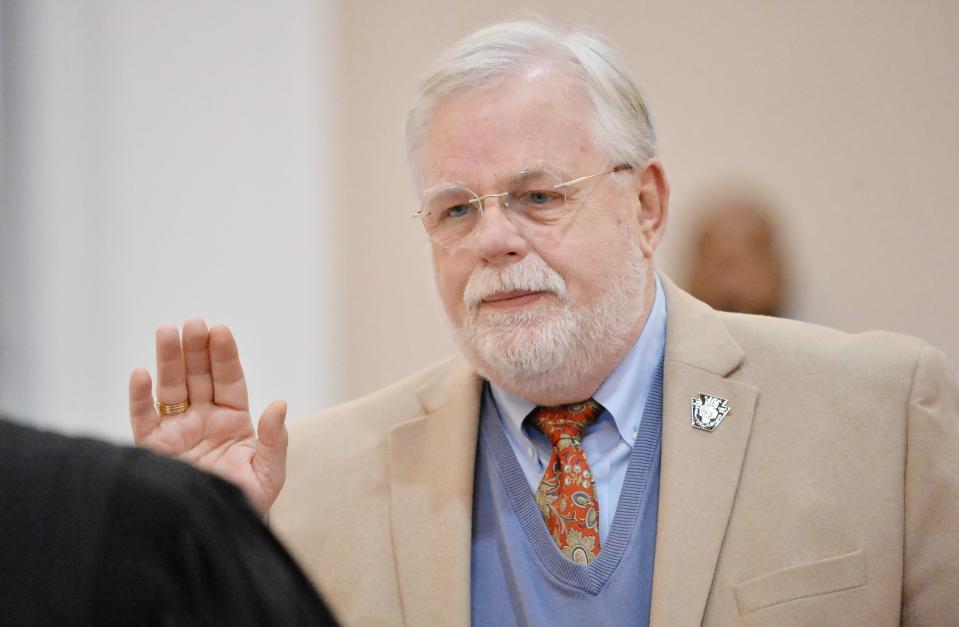 Lyell Cook is sworn in as Erie County coroner during the swearing-in ceremony on Tuesday.