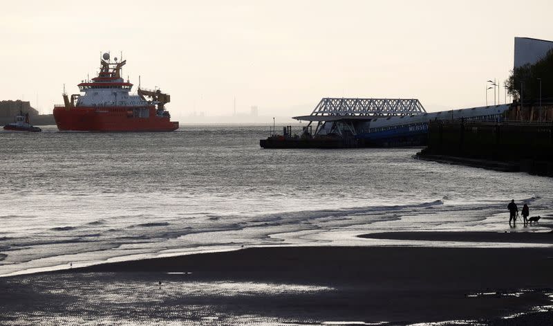 People watch as the RSS Sir David Attenborough leaves Liverpool to begin sea trials in New Brighton, Britain