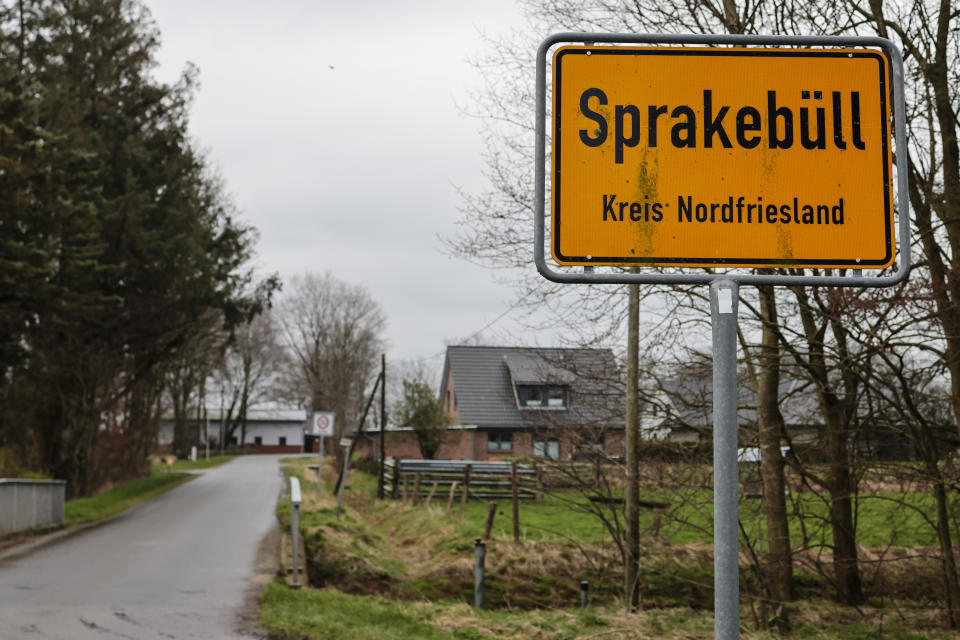 The town sign for Sprakebüll is at the side of the road in Sprakebuell, Germany, Thursday, March 14, 2024. Sprakebuell is something of a model village for the energy transition - with an above-average number of electric cars, a community wind farm and renewable heat from biogas. All houses in the village center have been connected to the local heating network and all old oil heating systems have been removed. (AP Photo/Frank Molter)