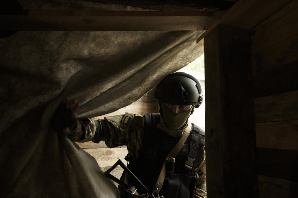 A Ukrainian National Guard soldier enters a underground shelter at a position near Kharkiv, Ukraine, Monday, May 9, 2022. (AP Photo/Felipe Dana)