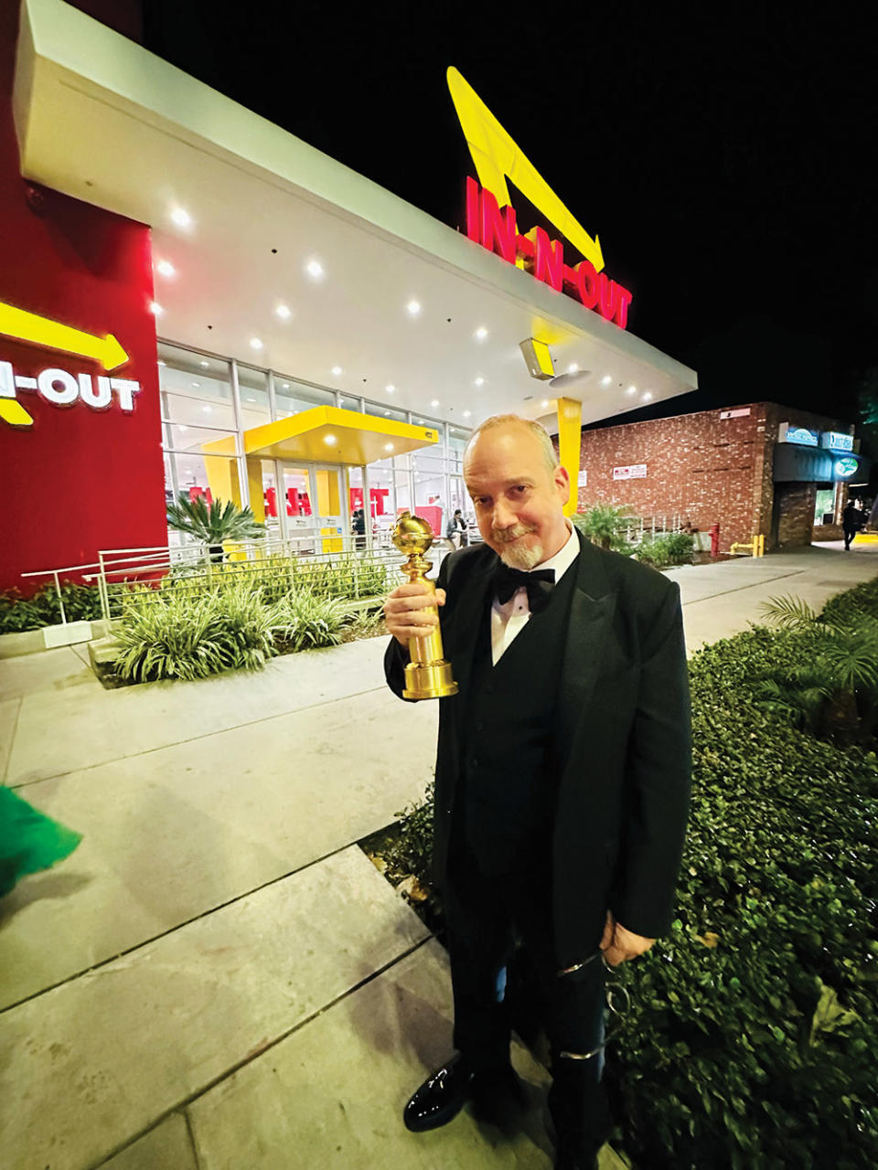 The Holdovers star Paul Giamatti brandishes his Golden Globe after a celebratory meal at In-N-Out.