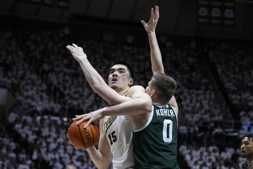 Purdue center Zach Edey (15) is fouled by Michigan State forward Jaxon Kohler (0) as he shoots during the second half of an NCAA college basketball game in West Lafayette, Ind., Sunday, Jan. 29, 2023. Purdue defeated Michigan State 77-61. (AP Photo/Michael Conroy)