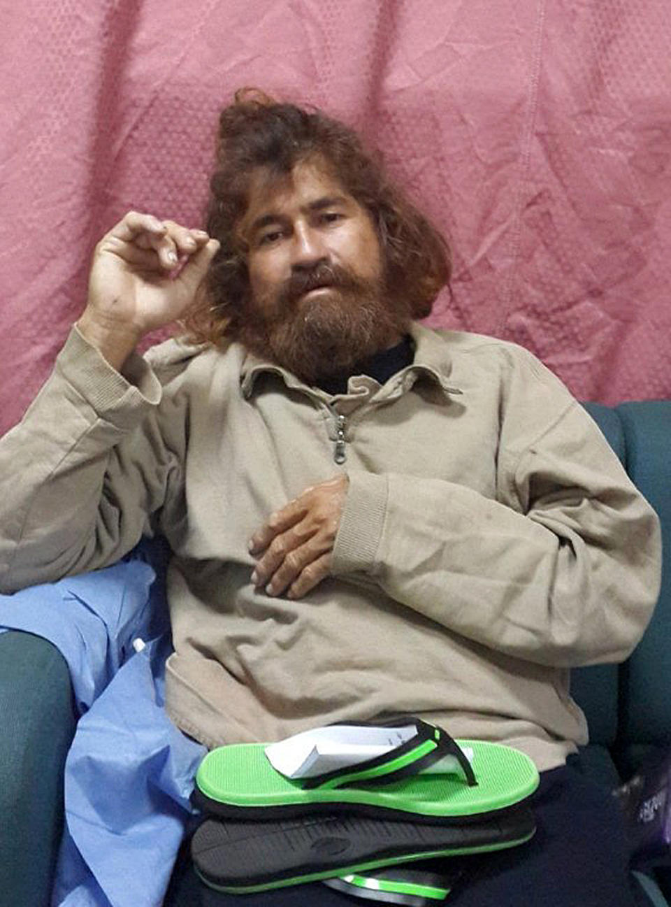 In this Monday, Feb. 3, 2014 photo provided by the Marshall Islands Foreign Affairs Department, a man identifying himself as 37-year-old Jose Salvador Alvarenga sits on a couch in Majuro in the Marshall Islands, after he was rescued from being washed ashore on the tiny atoll of Ebon in the Pacific Ocean. Alvarenga told the U.S. ambassador in the Marshall Islands Tom Armbruster and the nation's officials that he left Mexico in December 2012 for a day of shark fishing and ended up surviving 13 months on fish, birds and turtles before washing ashore on the remote Marshall Islands thousands of miles (kilometers) away. (AP Photo/Foreign Affairs Department The Marshall Islands, Gee Bing)