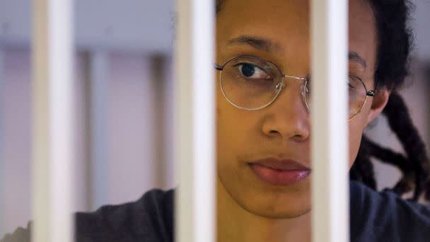 PHOTO: U.S. basketball player Brittney Griner looks through bars as she listens to the verdict standing in a cage in a courtroom in Khimki, outside Moscow, on Aug. 4, 2022. (Evgenia Novozhenina, Pool via AP)