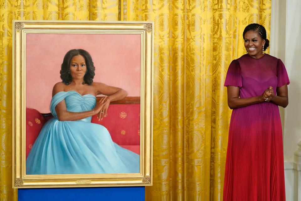 Former first lady Michelle Obama stands next to her official White House portrait during a ceremony in the East Room of the White House, Wednesday, Sept. 7, 2022, in Washington. The former first lady chose artist Sharon Sprung to do her portrait.
