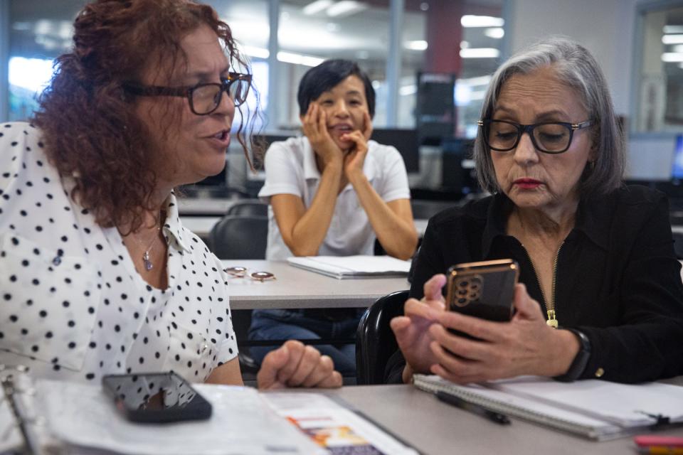 Agata Catania, from Italy, and Maria Luisa Flores, from Mexico, translate a sentence on a phone during a break at a Literacy for Caregivers English class on Wednesday, Aug. 23, 2023, in Corpus Christi, Texas.