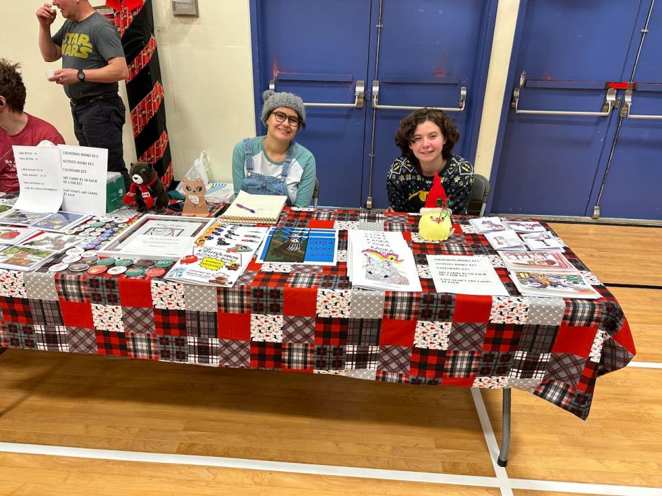 Sisters Myka and Trista Glada have been selling their activity books and calendars at craft fairs across Yukon. They said they draw inspiration from their mother who passed away five years ago. (Submitted by Kara Went - image credit)