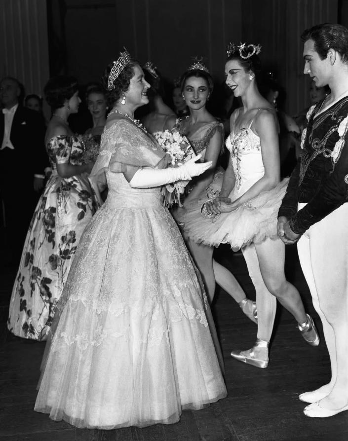 <p>The Queen Mother speaks with dancers after a 1939 gala performance at the Royal Opera House.</p>