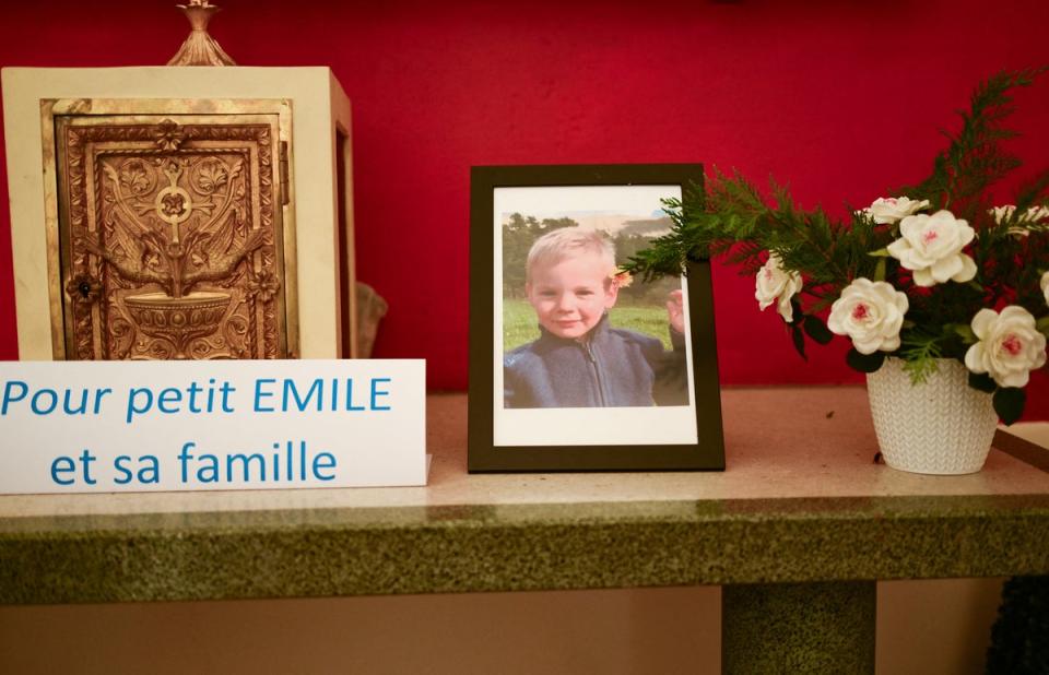 Inside a chapel in La Bouilladisse southern France, a card with the inscription reading ‘for little Emile and his family’ next to a photo of Emile (Getty)