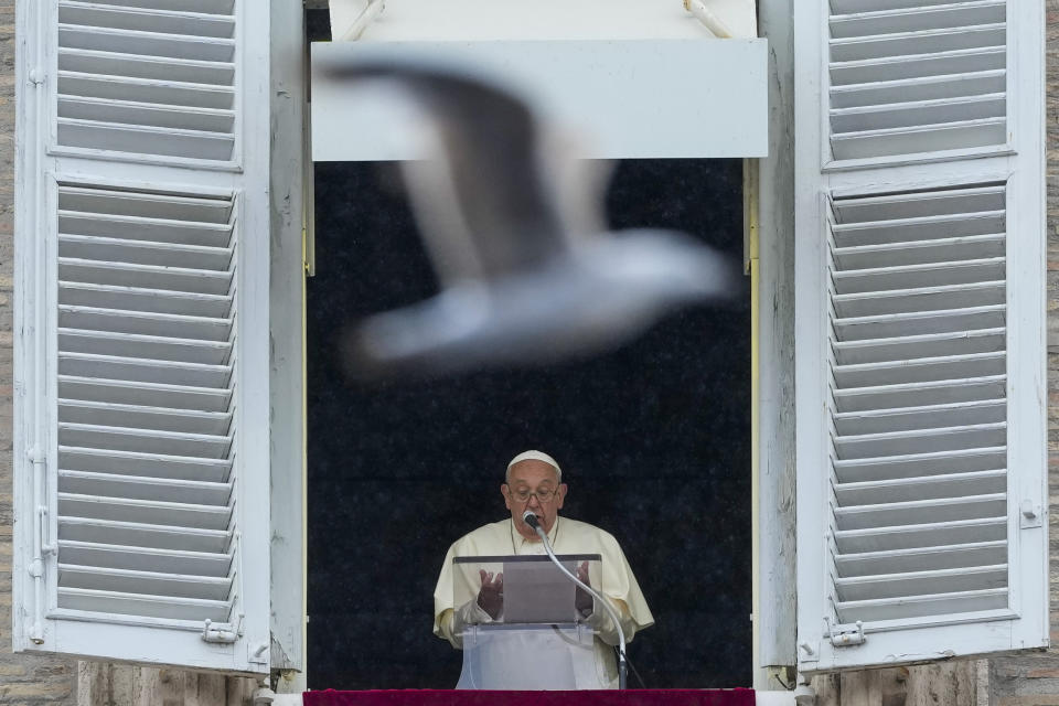 A seagull flies in front of Pope Francis as he speaks to the faithful gathered under pouring rain in St. Peter's Square at The Vatican for the traditional Sunday's noon blessing after the Angelus prayer, Sunday, June 2, 2024. (AP Photo/Alessandra Tarantino)