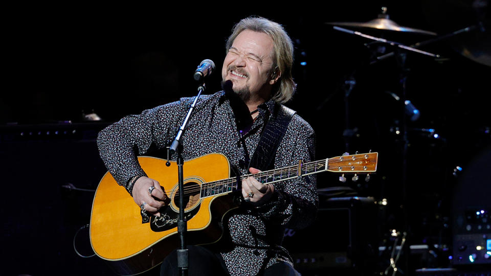 Travis Tritt performing gospel album on acoustic guitar