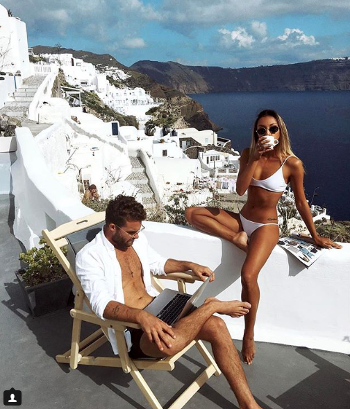 <p>The pair are seen posing in all white with the gorgeous Santorini town of Oia glistening stark white in the background.</p>