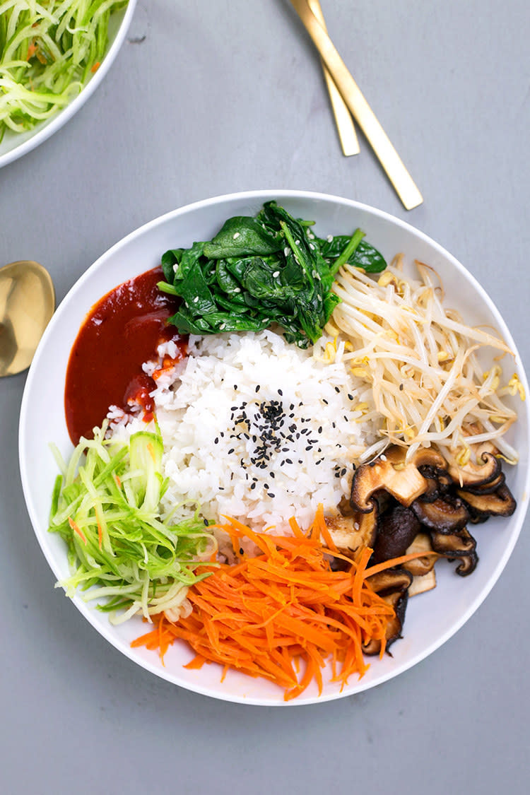 Rice, shredded veggies, and mushrooms on a plate