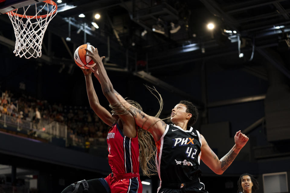 Phoenix Mercury center Brittney Griner (42) attempts to regain possession of the ball from Washington Mystics forward Queen Egbo during the first quarter of a WNBA basketball game, Sunday, July 23, 2023, in Washington. (AP Photo/Stephanie Scarbrough)