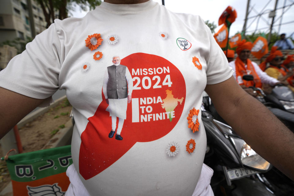 FILE-A supporter of India's ruling Bharatiya Janta Party (BJP) wears a t-shirt featuring photograph of Prime Minister Narendra Modi as he participates in a Vijay Visvas or faith in victory bike rally on the last day of campaign for the third phase of general elections, in Ahmedabad, India, Sunday, May 5, 2024. (AP Photo/Ajit Solanki,file)