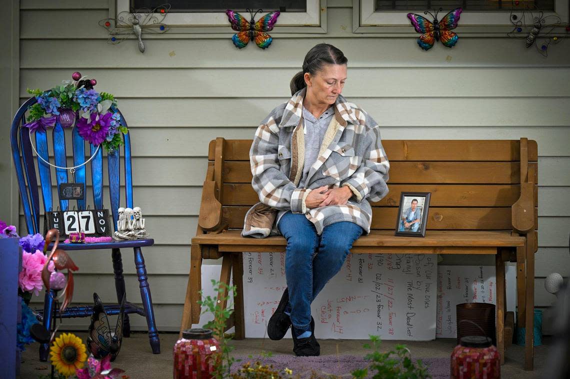 Linda Elder sits on the porch of her Kansas City home where she displays items on a purple chair to remember her son, Brandon Elder, 38, who died last November of fentanyl intoxication.