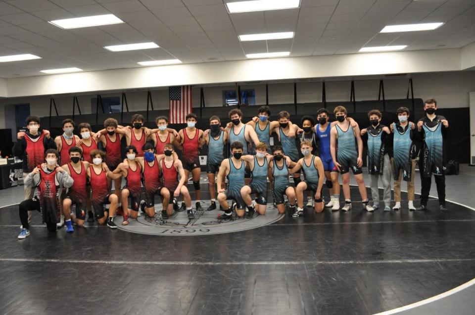 Collegiate School (red) and Hackley (blue) wrestling teams pose for a picture in their Pin Cancer singlets at the Pin Cancer fundraising meet at the Hackley School on Jan. 21, 2022.