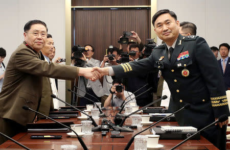 North Korean Lieutenant General An Ik San shakes hands with South Korean Major General Kim Do-gyun during a meeting at the Peace House of the border village of Panmunjom, South Korea, July 31, 2018. Yonhap via REUTERS