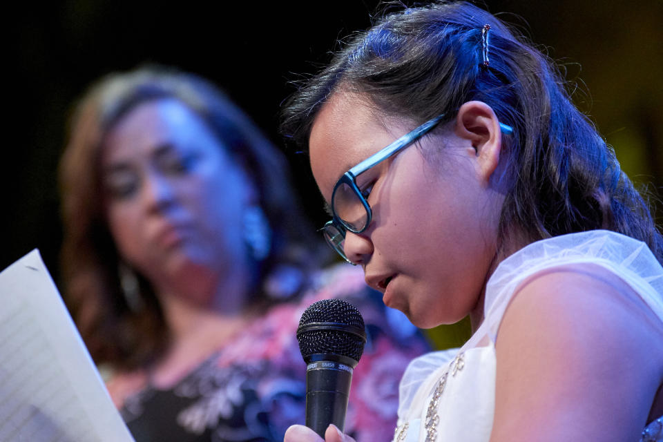 Michelle Benson looks on as her daughter Mei Mei spoke recently at a fundraising event for One Heartland. (One Heartland)
