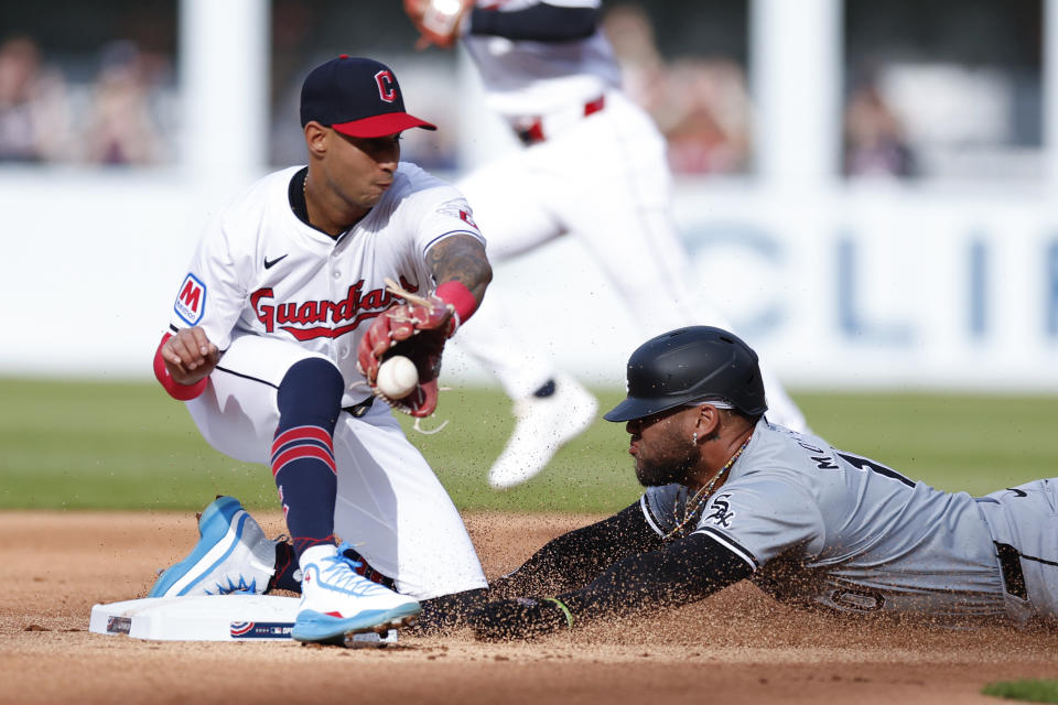 RETRANSMISSION TO CORRECT ID TO BRAYAN ROCCHIO - Chicago White Sox's Yoán Moncada, right, steals second base as Cleveland Guardians shortstop Brayan Rocchio takes the throw during the first inning of a baseball game, Monday, April 8, 2024, in Cleveland. (AP Photo/Ron Schwane)