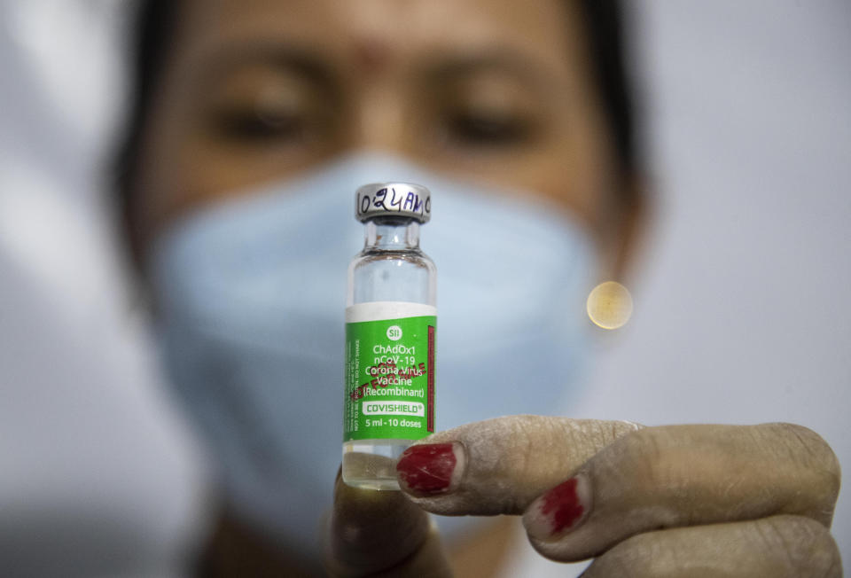 A health worker shows COVISHIELD vaccine before administering it to an elderly person in Gauhati, India, Monday, March 1, 2021. India is expanding its COVID-19 vaccination drive beyond health care and front-line workers, offering the shots to older people and those with medical conditions that put them at risk. (AP Photo/Anupam Nath)