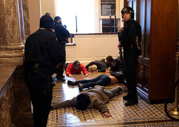 WASHINGTON, DC - JANUARY 06: U.S. Capitol Police stand detain protesters outside of the House Chamber during a joint session of Congress on January 06, 2021 in Washington, DC. Congress held a joint session today to ratify President-elect Joe Biden's 306-232 Electoral College win over President Donald Trump. A group of Republican senators said they would reject the Electoral College votes of several states unless Congress appointed a commission to audit the election results. (Photo by Drew Angerer/Getty Images)