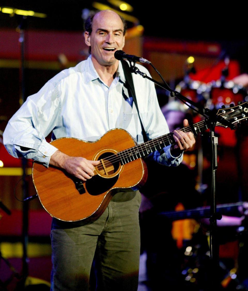 James Taylor performs for his fans during his summer concert tour at the AmSouth Ampitheatre in Nashville May 26, 2003.