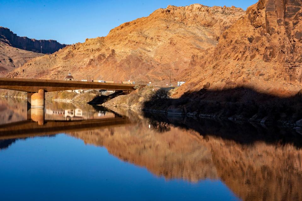 The Colorado River flows under a bridge in Moab, Utah.