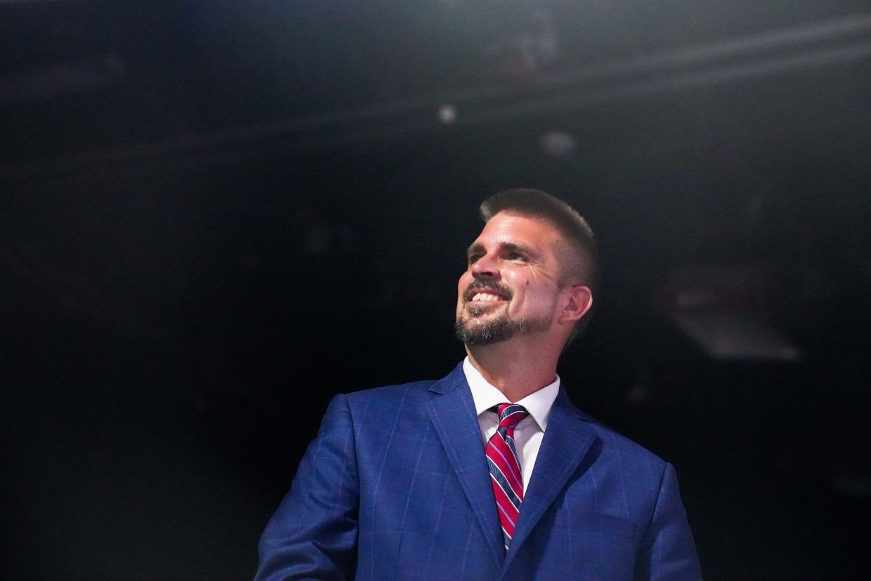 Scott Neely talks with other candidates before a debate with Republican candidates ahead of the Aug. 2 primary election for the Arizona Governor's Office in Phoenix.