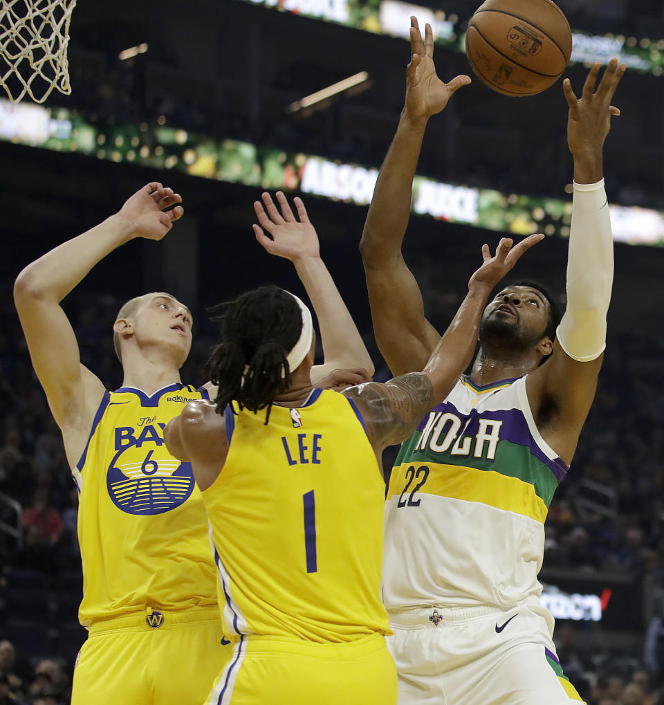 New Orleans Pelicans' Derrick Favors, right, rebounds the ball over Golden State Warriors' Alen Smailagic, left, and Damion Lee (1) during the first half of an NBA basketball game Sunday, Feb. 23, 2020, in San Francisco. (AP Photo/Ben Margot)