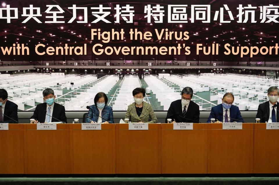 Hong Kong Chief Executive Carrie Lam and other government officials listen to reporters' questions during a press conference in Hong Kong, Friday, Aug. 7, 2020. The semi-autonomous city of Hong Kong reports 95 new cases and three additional fatalities reported. The city of 7.5 million people has restricted indoor dining and require faces masks to be worn in all public places. (AP Photo/Vincent Yu)