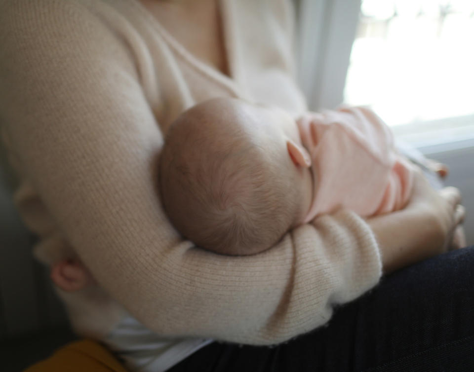closeup of a baby cradled in arms