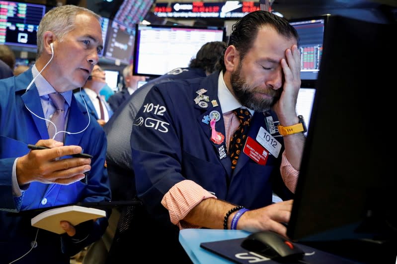 Traders work on the floor at the NYSE in New York