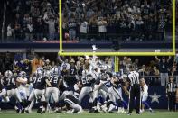 Fans look on as Las Vegas Raiders' Daniel Carlson (2) kicks a game-winning field goal in overtime of an NFL football game against the Dallas Cowboys in Arlington, Texas, Thursday, Nov. 25, 2021. (AP Photo/Ron Jenkins)